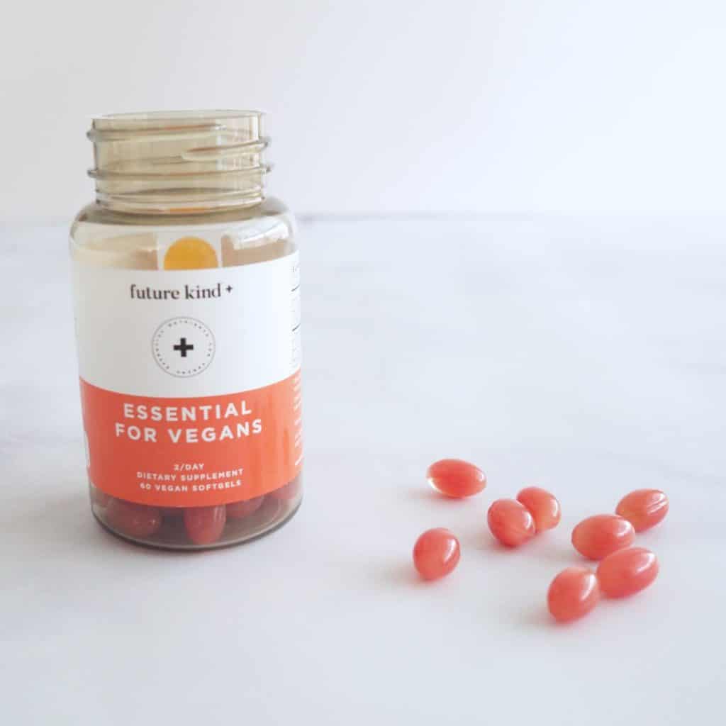 future kind essential vitamin for vegans bottle with pills on marble countertop