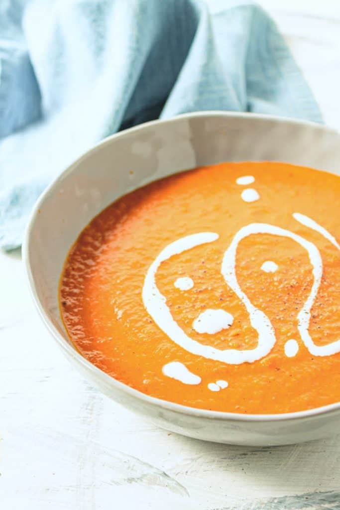 closeup of the creamy vegan tomato curry soup with coconut milk