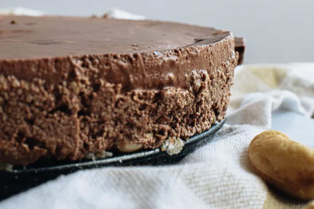 closeup of chilled raw chocolate cake still in cake pan