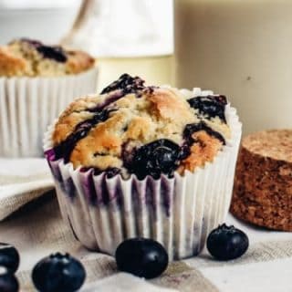 simple vegan blueberry muffin closeup with fresh blueberries