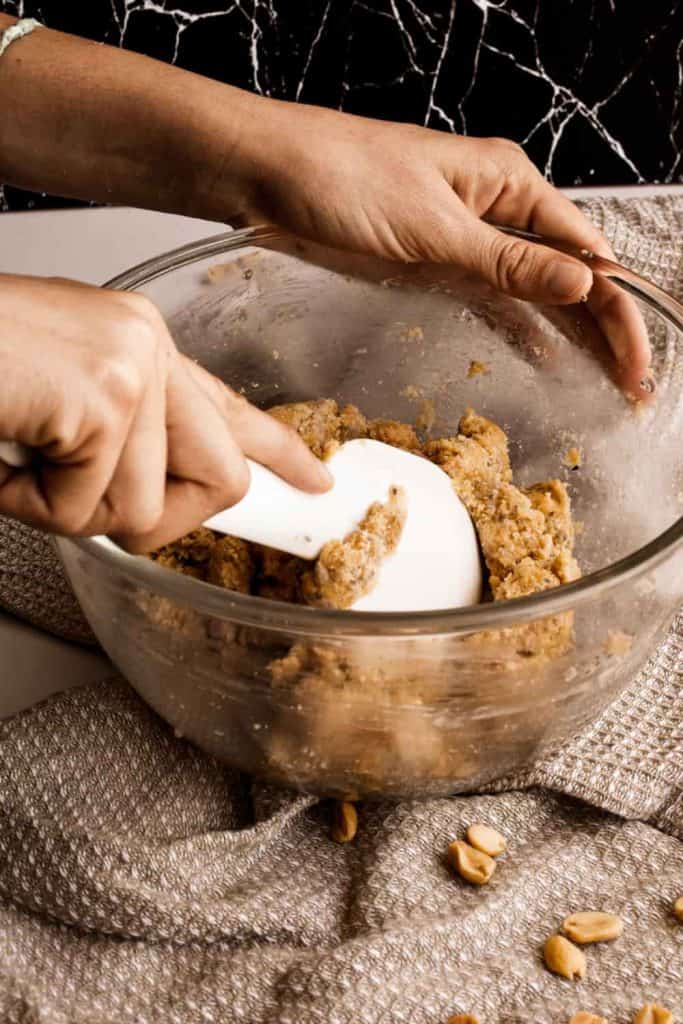 mixing the vegan peanut butter ball dough in bowl