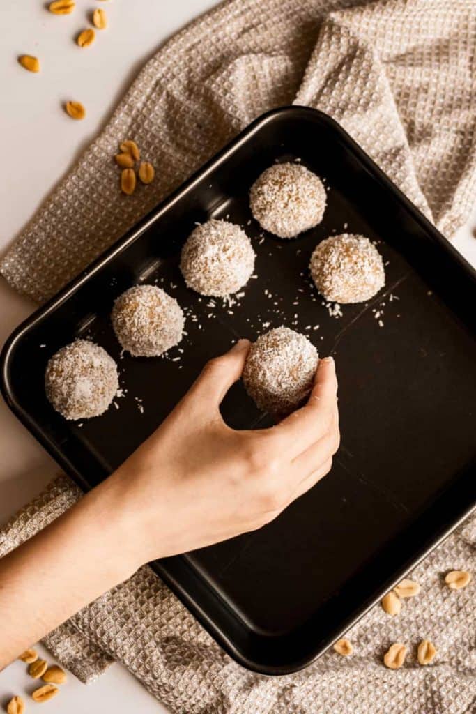 placing no-bake peanut butter balls onto a serving tray