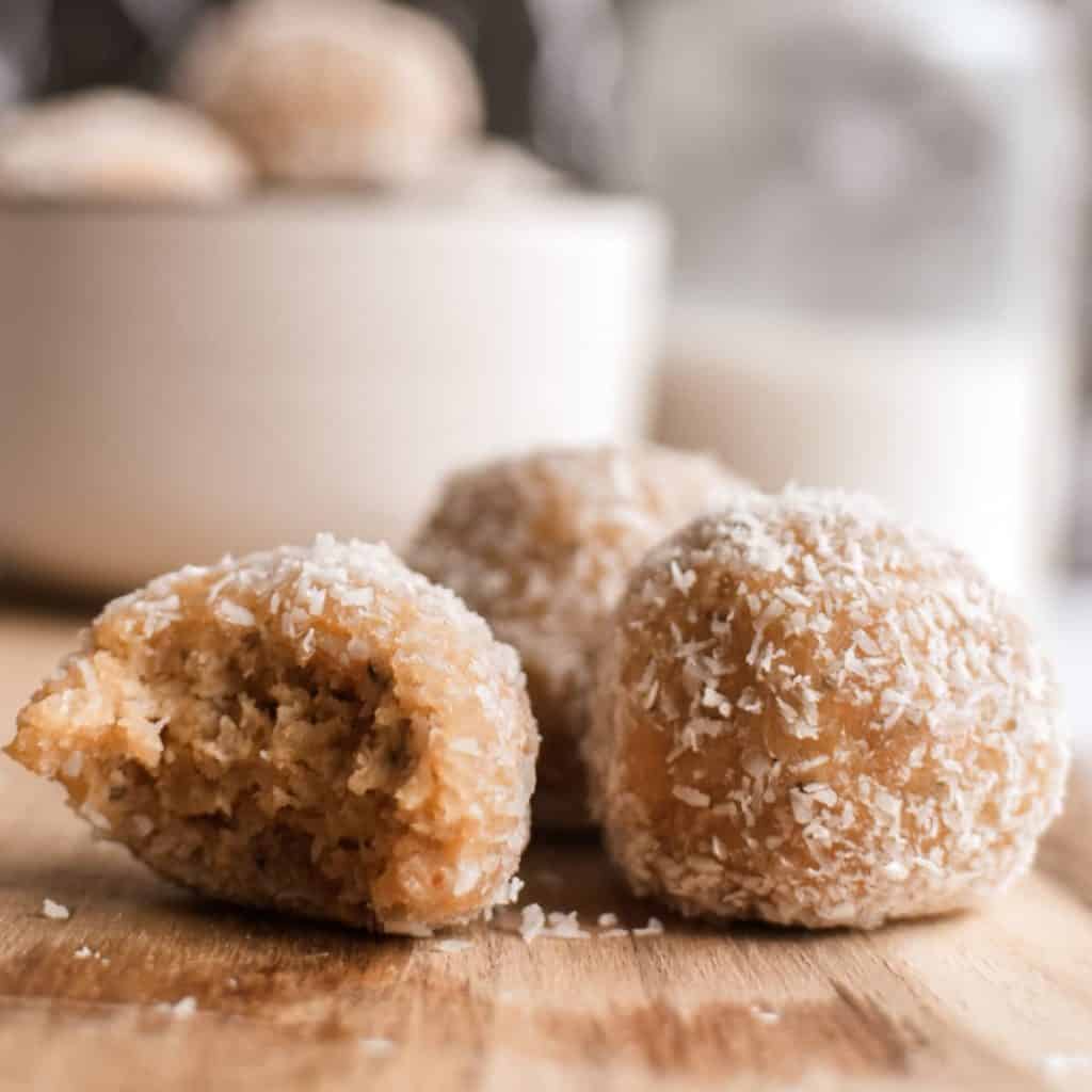 close up of vegan no bake peanut butter balls with coconut