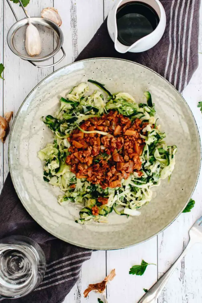 overhead view of plated zoodles with high protein vegan bolognese