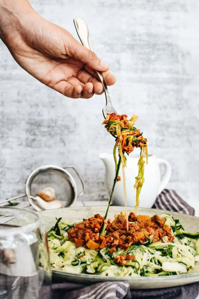 forkful of protein-filled vegan bolognese with zoodles