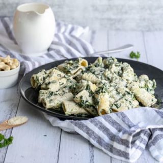 closeup of spinach artichoke pasta on plate