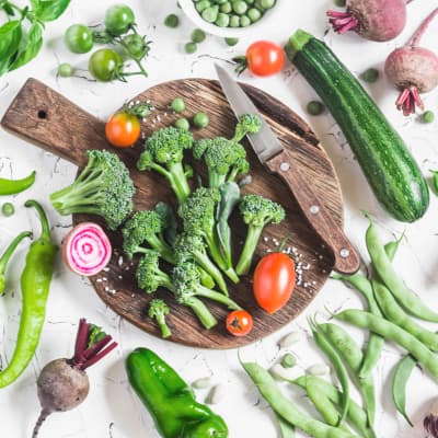 garden veggie flat lay with wooden board and knife