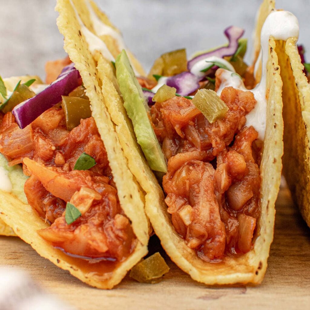 vegan bbq jackfruit tacos in corn tortilla close up